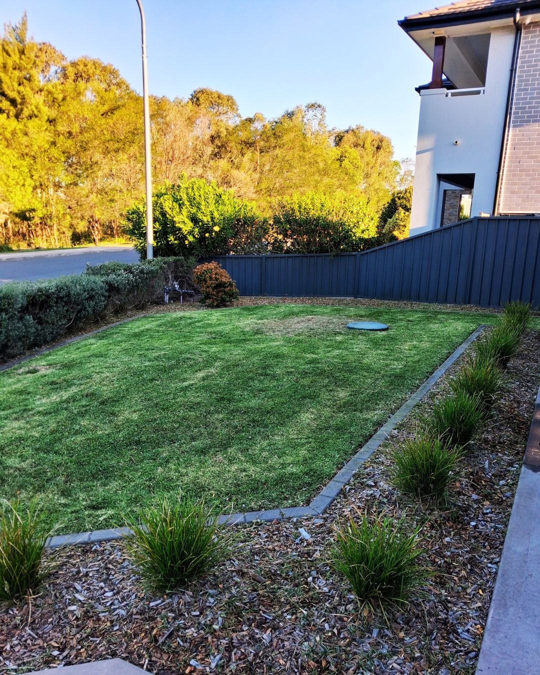 Freshly mowed front lawn beside garden beds in Kellyville, NSW